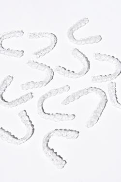 Picture with a white background showing full sets of invisible aligners from Eon Aligner